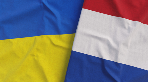 Flags of Ukraine and the Netherlands. Linen flags close up. Flag made of canvas.