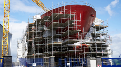 Shipbuilding and crane during ferry construction surrounded by scaffold