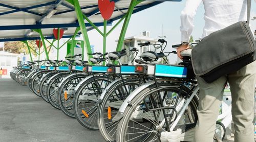 Office worker takes e-bike from bicycle sharing system station